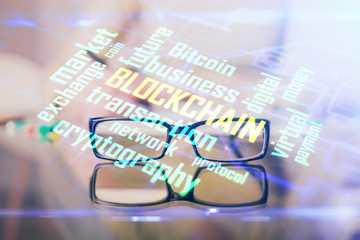 Cryptocurrency hologram over woman's hands writing background. Concept of blockchain. Multi exposure