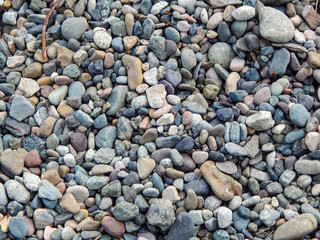 Background of Colorful Beach Rocks in Hues of Red, Gray, Green, Yellow and Blue