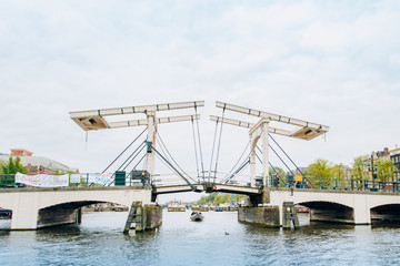 Fototapeta na wymiar Amsterdam, Netherlands September 5, 2017: Magere Brug Bridge and Amstel river.