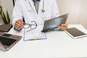 Medicine and health care concept. Doctor diagnose and analyze on x-ray film of patient.