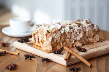 Table with yeasty sweet pastry with fresh cherries and streusel topping, cup of tea and few cubes of sugar. Summer fresh fruit appetizer