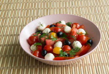 Salad with tomatoes, olives and mozzarella cheese