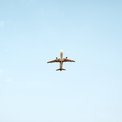 Airplane flying in blue sky. Travel, vacation and holiday concept.