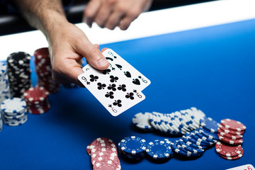 Man playing Texas Hold 'em poker at Casino