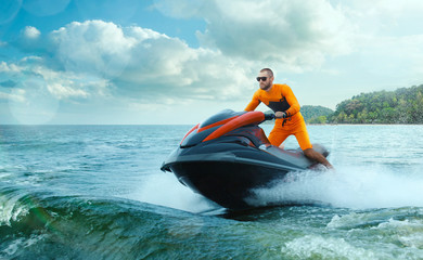 Young Man on water scooter, Tropical Ocean, Vacation Concept. Jet Ski. Sea.