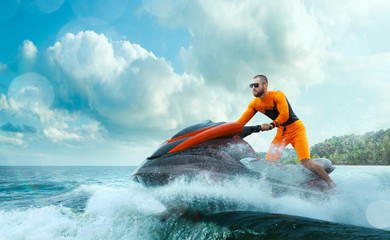 Young Man on water scooter, Tropical Ocean, Vacation Concept. Jet Ski. Sea.