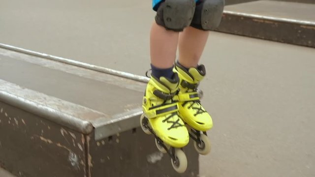 Speed rollerblade hobby. Young confident boy performing trick on small ramp