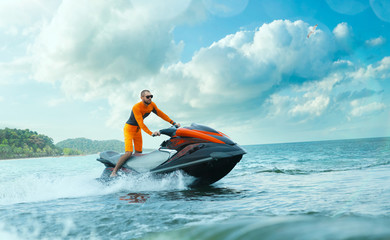 Young Man on water scooter, Tropical Ocean, Vacation Concept. Jet Ski. Sea.