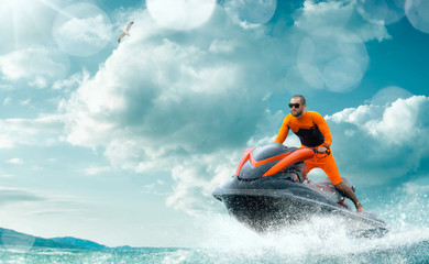 Young Man on water scooter, Tropical Ocean, Vacation Concept. Jet Ski. Sea.