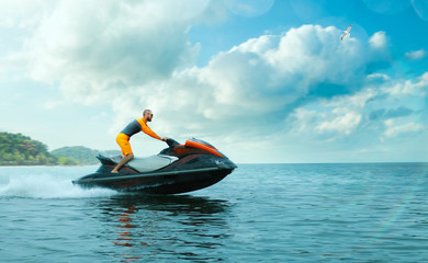 Young Man on water scooter, Tropical Ocean, Vacation Concept. Jet Ski. Sea.