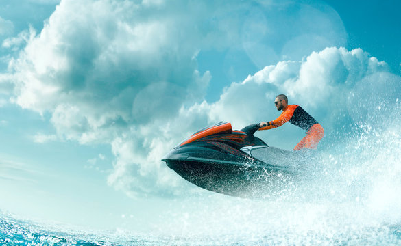 Young Man on water scooter, Tropical Ocean, Vacation Concept. Jet Ski. Sea.