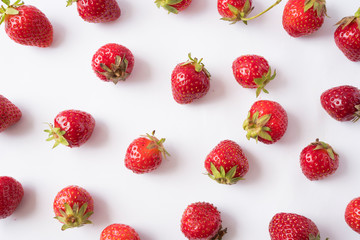 Fresh strawberries scattered on white background. Strawberries on a white background. Fruits with...