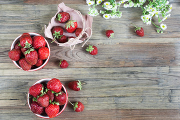 Two plates of fresh strawberreis on wooden background. Vegetarian breakfast