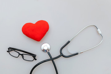 Simply minimal design with medicine equipment stethoscope or phonendoscope glasses and red heart isolated on white background. Instrument device for doctor. Health care life insurance concept