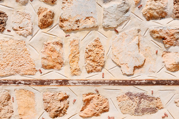 Stone masonry of an ancient fortress. Retro or grunge texture. Abstract image of a stone wall. Light background.