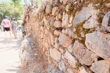 Stone masonry of an ancient fortress. Retro or grunge texture. Abstract image of a stone wall. Light background.