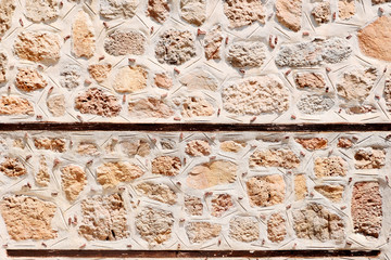 Stone masonry of an ancient fortress. Retro or grunge texture. Abstract image of a stone wall. Light background.