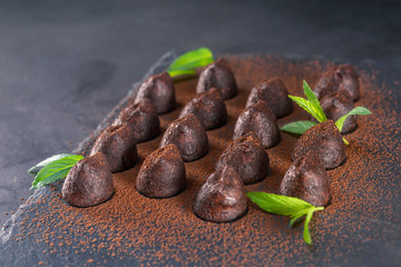 Homemade chocolate truffles with mint sprinkled with cocoa powder