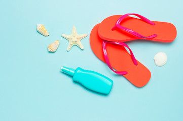 Summer beach sea accessories. Coral flip flops, shells, starfish, yellow sunscreen bottle, body...