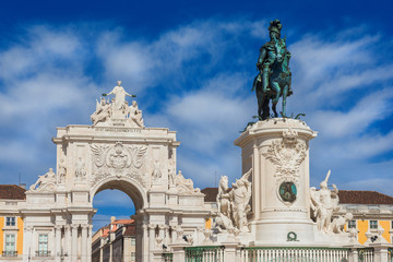 Fototapeta na wymiar Triumphal Arch and King Jose I bronze statue in the iconic Commerce Square in the very centre of Lisbon