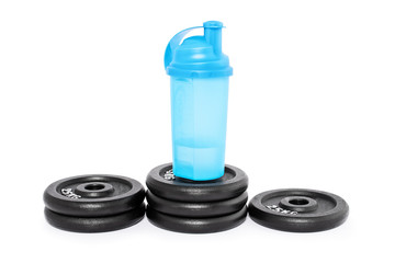Protein shaker on a pedestal of weight plates