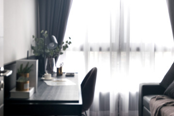 Defocused curtain window and stationery desk with sunlight.