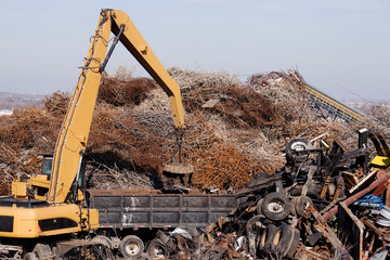 Excavator Moving Scrap Metal with Electro Magnet