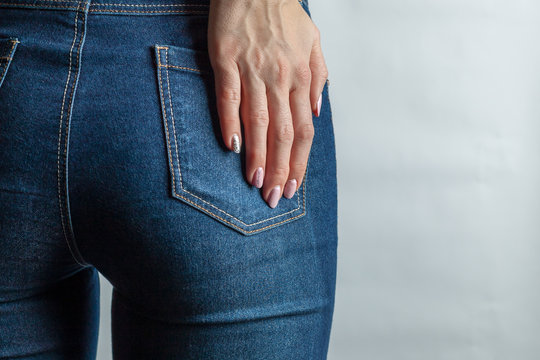 young woman behind in denim jeans. holds her hand at back pocket. hard  light. concept beauty and healthy lifestyle. copy space Stock Photo | Adobe  Stock