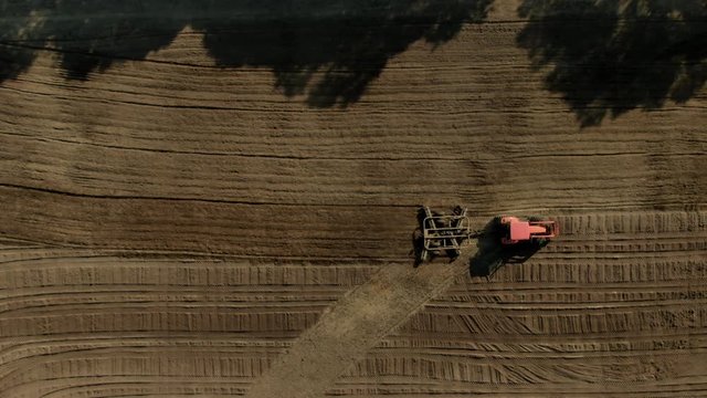 Aerial Drone Shot of Tractor Discing Soil For Planting Crop, British Columbia Canada