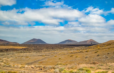 Volcanic hills in the desert landscape of the island of Lanzarote, which is a protected area of UNESCO