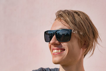 Young th guy in sunglasses on the street