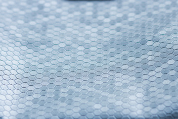 silver metal texture of a plurality of hexagons. a beautiful backdrop gray color