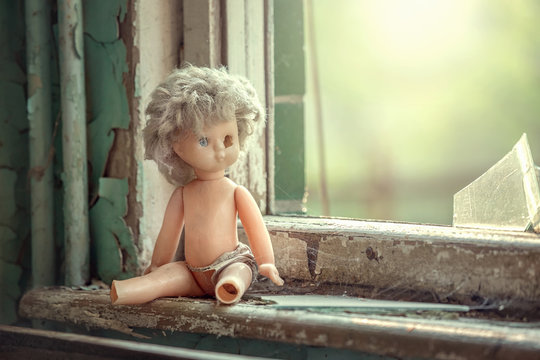Broken doll near the window in abandoned school in Pripyat, Chernobyl alienation zone