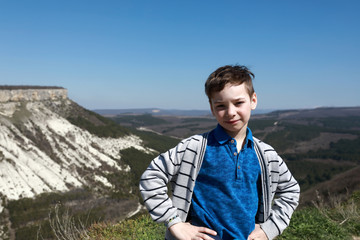 Naklejka premium Boy on Crimean Mountains background