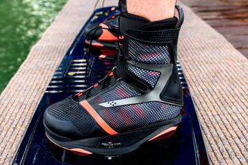 Equipment for wakeboarding. Man wears wake shoes