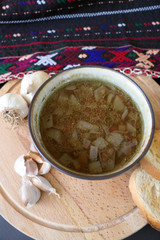 Warm Homemade Lentils Soup with Garlic and Bread Slices on a Dark Background