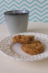 Cookies in a Plate with Caffee on a White and Green Zigzag Background