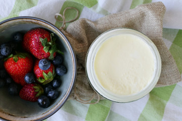 Homemade Yoghurt with Fresh Strawberries and Blueberries on a Wooden Background
