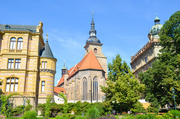 Beautiful Franciscan Monastery in Plzen, Czech Republic photographed from the park in Krizikovy sady. Medieval architecture, landmarks. Pilsen, Western Bohemia, Czechia. Sunny day