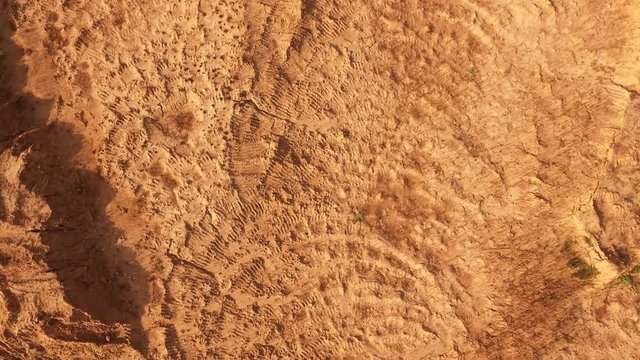 Aerial view of red sand in a desert or wilderness in summer day. Sene. View from above of sand textures