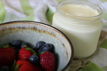 Homemade Yoghurt with Fresh Strawberries and Blueberries on a Wooden Background