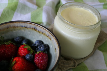 Homemade Yoghurt with Fresh Strawberries and Blueberries on a Wooden Background