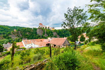 View of beautiful castle Vranov nad Dyji, Moravian region in Czech republic. Ancient chateau built in baroque style, placed on big rock above river near the Vranov village. Cloudy weather.