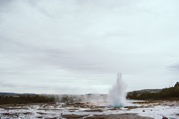 Stages of the eruption of the famous Strokkur Geyser In Iceland on a cold cloudy afternoon. Giant blue bubble right before the eruption