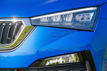 Fototapeta na wymiar Front lights of a blue car
