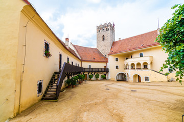 View of beautiful castle Vranov nad Dyji, Moravian region in Czech republic. Ancient chateau built in baroque style, placed on big rock above river near the Vranov village. Cloudy weather.