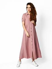 Young beautiful woman walking in new design casual summer long dress full body on white