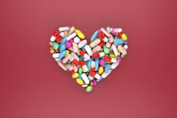 Heart of pills on red