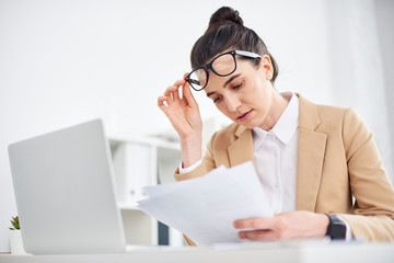 Mid age businesswoman working with document in office