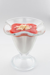 Sugar free panna cotta, based on coconut milk, strawberry puree, orange jelly, decorated with flaked almonds as a perfect dietary treat